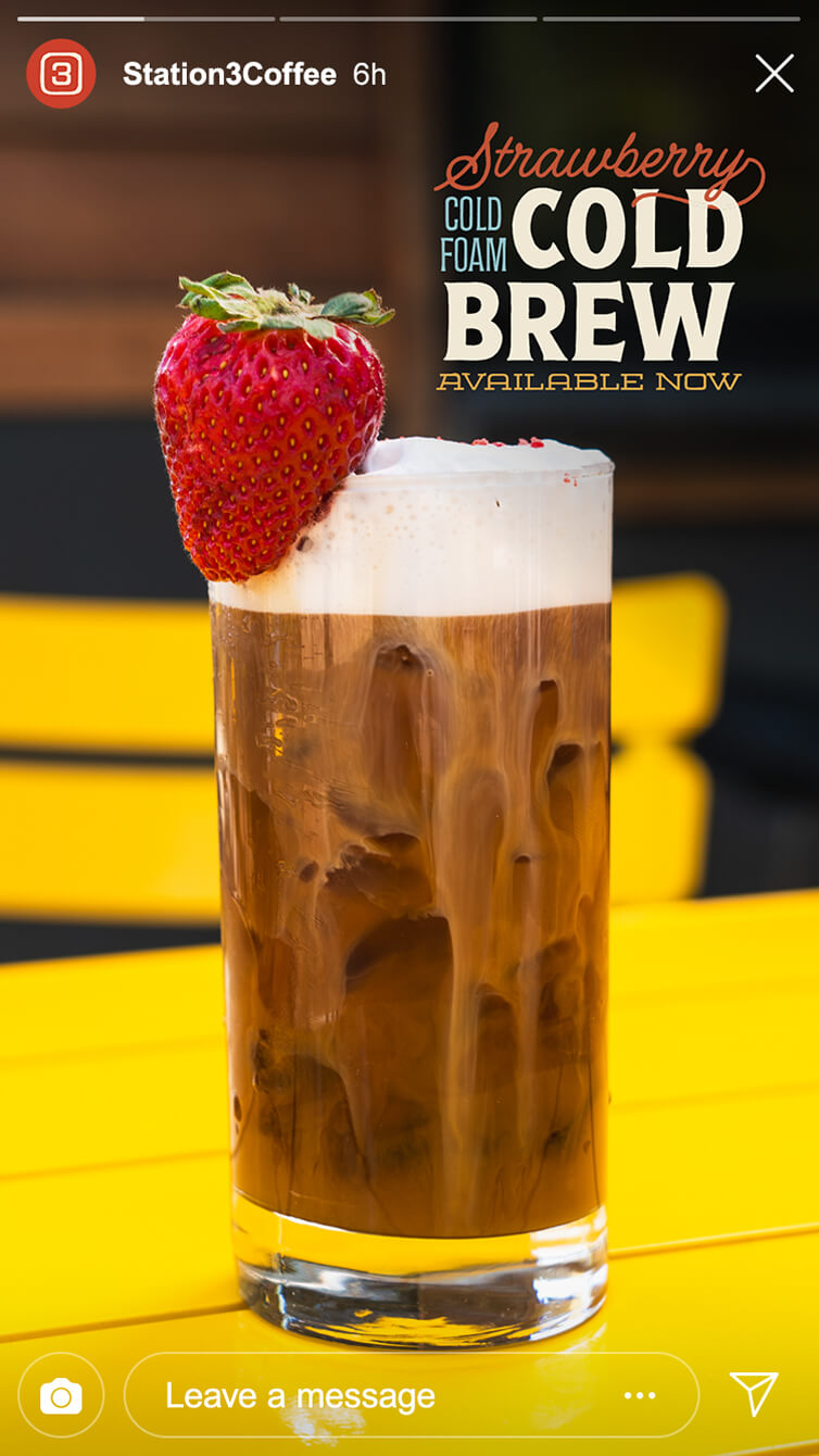 Tall glass of iced cold brew topped with frothy strawberry cold foam and a fresh strawberry garnish, with promo text overlay.