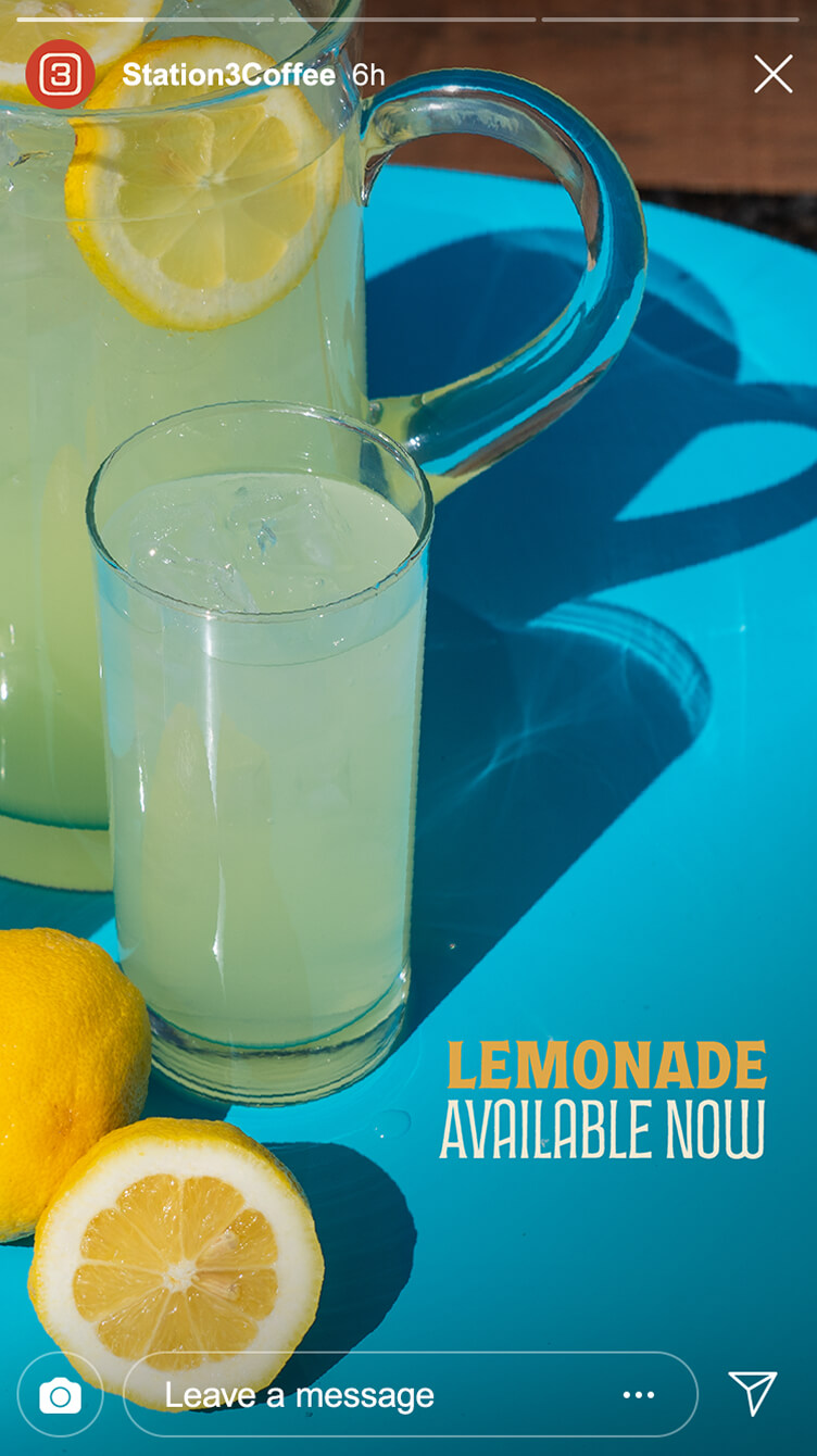 Glass pitcher and tall glass of iced lemonade with lemon slices, set on a bright blue surface with fresh lemons, and promo text overlay.